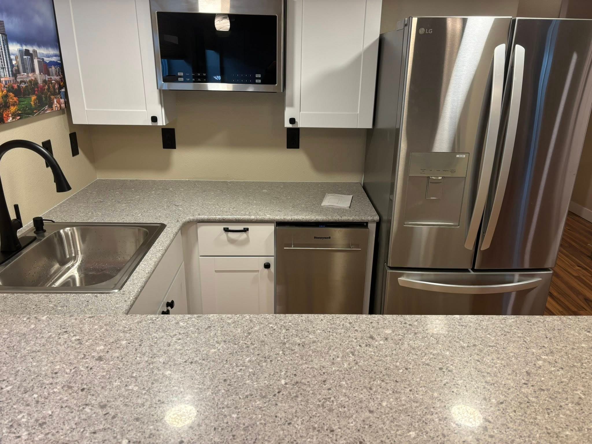 Quartz countertop detail with stainless appliances